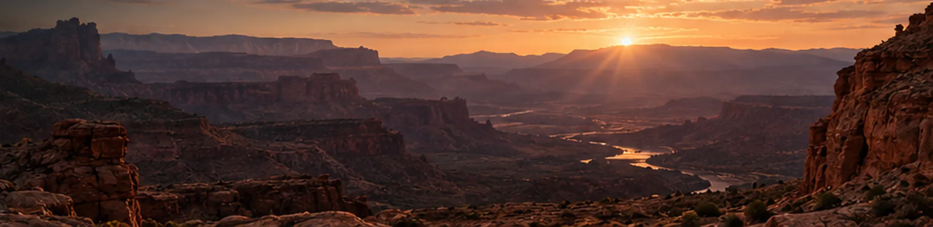 Slickrock canyons and the Colorado River at sunset